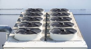 large rooftop HVAC unit with multiple cooling fans arranged in two rows