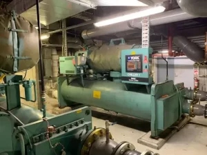 Industrial YORK chiller unit inside a mechanical room used for large-scale HVAC cooling operations.
