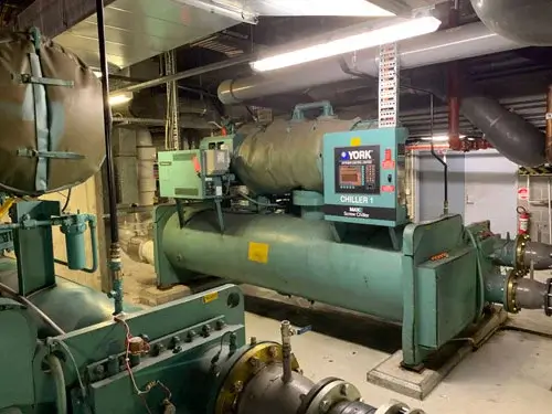 Industrial YORK chiller unit inside a mechanical room used for large-scale HVAC cooling operations.